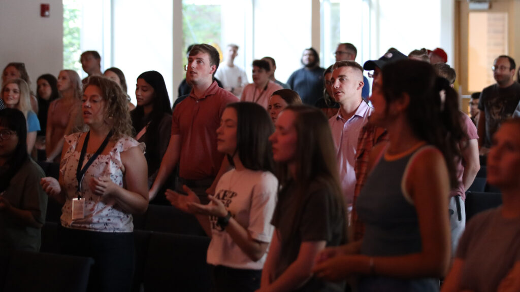 young adults standing at worship at REVIVE